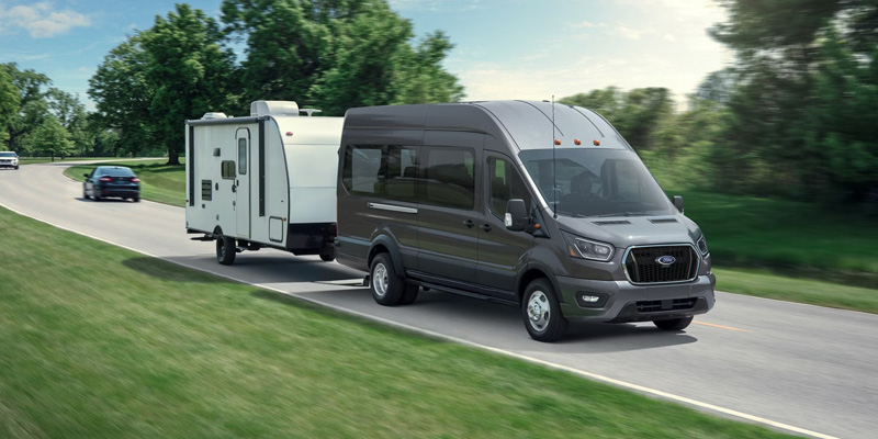A 2026 Ford Transit ready to haul with a trailer hitched for additional storage in Benton, AR 