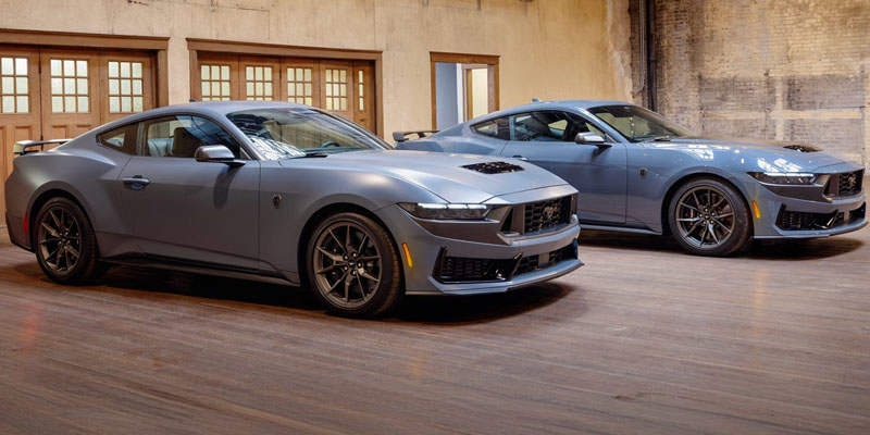 Two Ford Mustang cars displayed indoors