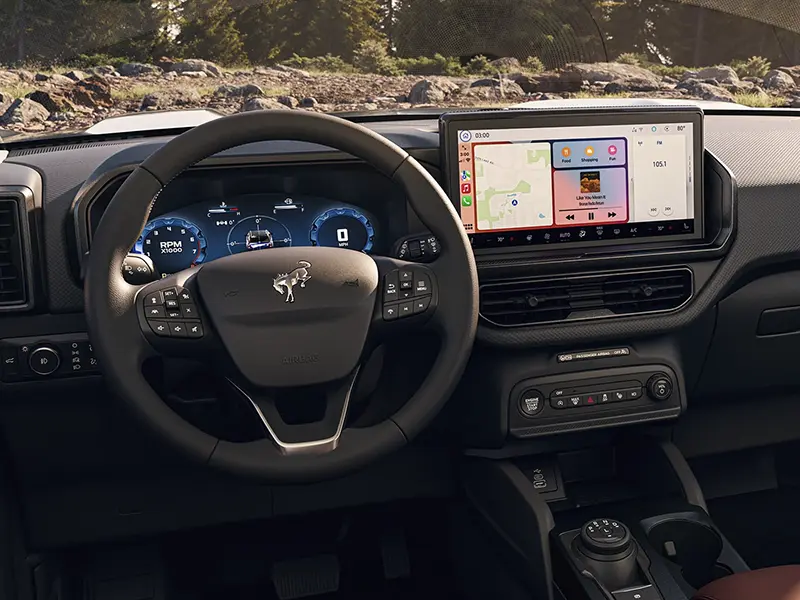 Interior of Ford SUV showing steering wheel, digital dashboard, and infotainment screen