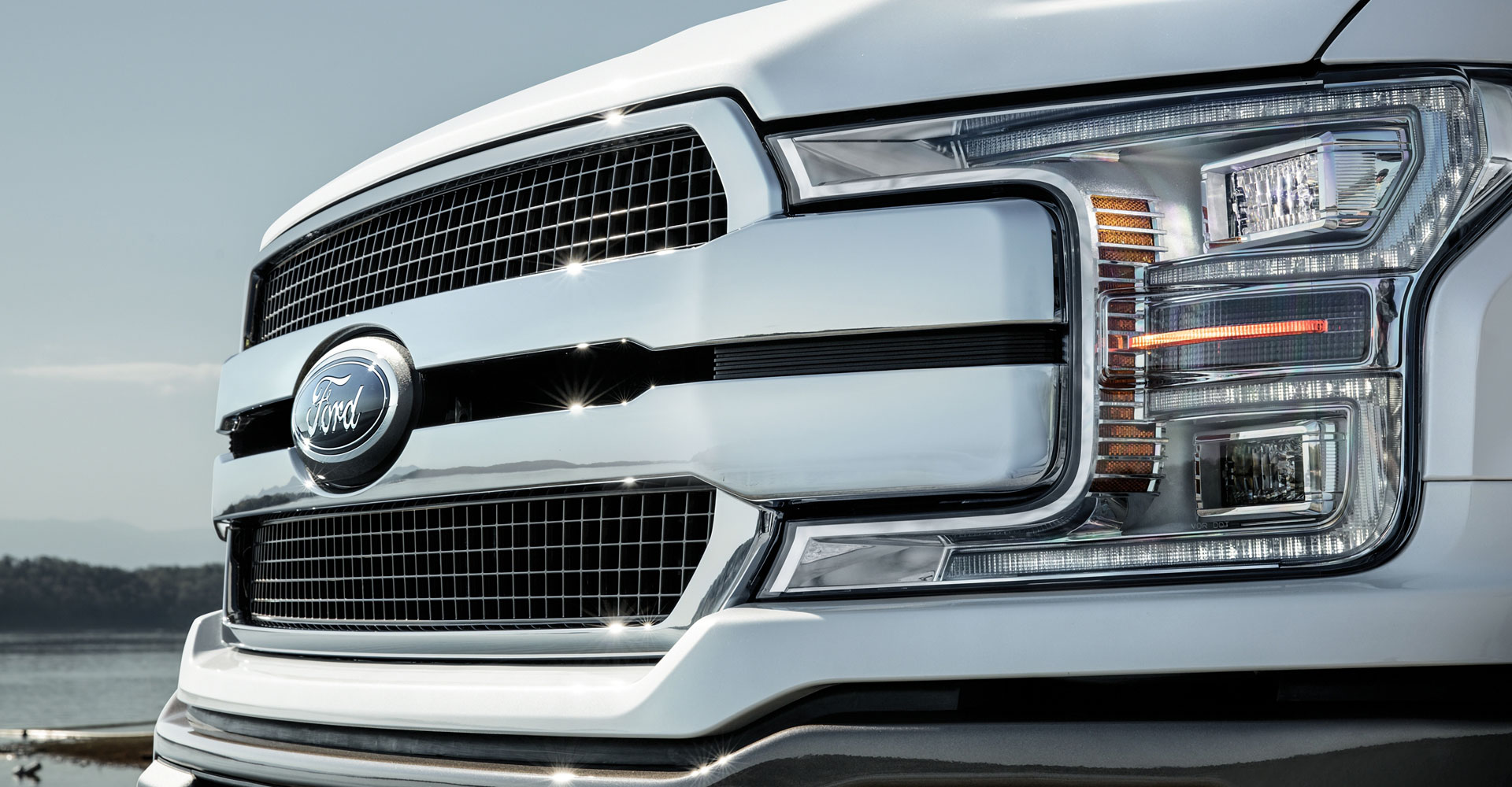 Close-up of Ford truck front grille and headlight