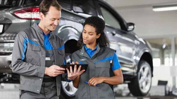 Ford service technicians reviewing vehicle inspection