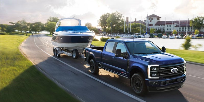 2026 Ford F-350 Super Duty towing a boat through a Benton, AR neighborhood with truck capability