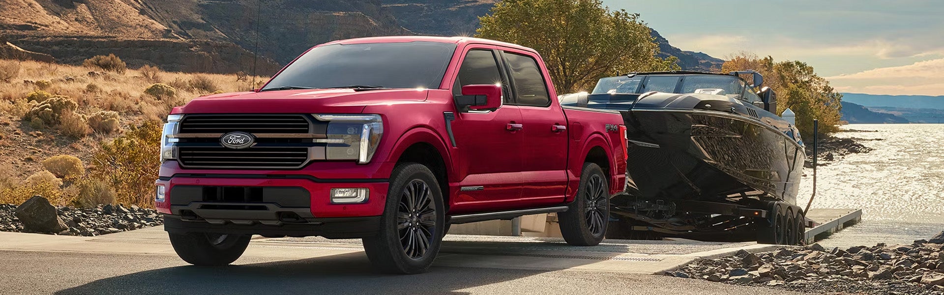 Ford F-150 towing boat near lake ramp